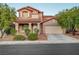 Charming two-story home with a well-manicured lawn, mature trees, and an attached two-car garage at 1011 Pecos River Ave, Henderson, NV 89002