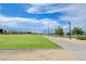 Open green space with a walking path, street lights, and distant mountain views beyond a playground at 1011 Pecos River Ave, Henderson, NV 89002