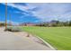 Picturesque community green space with walking path, set against a backdrop of mountains and blue sky at 1011 Pecos River Ave, Henderson, NV 89002