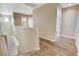Upstairs hallway boasts wood-look flooring and neutral paint, connecting various rooms at 1011 Pecos River Ave, Henderson, NV 89002