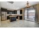 Open kitchen with stainless steel appliances, dark wood cabinets, and backyard access at 1011 Pecos River Ave, Henderson, NV 89002