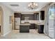 Open kitchen featuring stainless steel appliances, dark wood cabinets and island at 1011 Pecos River Ave, Henderson, NV 89002