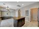 Kitchen island with seating area, stainless steel fridge and view to living room at 1011 Pecos River Ave, Henderson, NV 89002