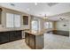 Open kitchen with center island, stainless steel appliances and view to living room at 1011 Pecos River Ave, Henderson, NV 89002