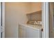 A view of a simple laundry room with a white washer and dryer at 1011 Pecos River Ave, Henderson, NV 89002