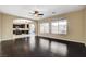 Open living room with hardwood floors connecting to the kitchen with ample natural light from the windows at 1011 Pecos River Ave, Henderson, NV 89002