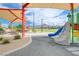 Modern playground with climbing walls, slides, and picnic tables, set against a mountain backdrop at 1011 Pecos River Ave, Henderson, NV 89002