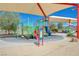 Colorful playground with slides, ladders, and climbing features under a shaded canopy at 1011 Pecos River Ave, Henderson, NV 89002