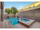 Backyard features a pool and spa with a brick wall and desert landscaping at 1011 Pecos River Ave, Henderson, NV 89002