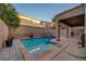 A view of a private backyard pool with a jacuzzi and covered patio at 1011 Pecos River Ave, Henderson, NV 89002