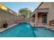 A view of a private backyard pool with a jacuzzi and covered patio at 1011 Pecos River Ave, Henderson, NV 89002
