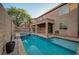 A view of a private backyard pool with a jacuzzi and covered patio at 1011 Pecos River Ave, Henderson, NV 89002