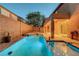Relaxing outdoor pool and spa area with a covered patio for enjoying the backyard oasis at 1011 Pecos River Ave, Henderson, NV 89002