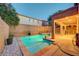 Backyard pool and spa featuring a rock waterfall feature and a covered patio perfect for entertaining at 1011 Pecos River Ave, Henderson, NV 89002