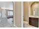 Powder room with pedestal sink and dark wood cabinet at 1011 Pecos River Ave, Henderson, NV 89002