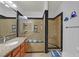 Updated bathroom featuring a walk-in glass shower and granite countertop at 10205 Camborne Ave # 104, Las Vegas, NV 89144
