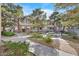 Exterior view of community with sidewalks, mature trees, and landscaping at 10205 Camborne Ave # 104, Las Vegas, NV 89144