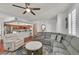 Bright and airy living room adjacent to the kitchen, featuring a sectional sofa, fireplace and hardwood floors at 10205 Camborne Ave # 104, Las Vegas, NV 89144