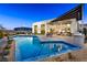 Resort-style backyard featuring a luxurious pool and spa, outdoor kitchen, and a spacious covered patio at 10848 Vista Altura Ave, Las Vegas, NV 89135