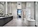 Elegant bathroom with a soaking tub, walk-in shower, dual sinks and modern fixtures at 10848 Vista Altura Ave, Las Vegas, NV 89135