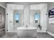 Luxurious bathroom boasting a standalone tub between dual glass-enclosed walk-in showers at 10848 Vista Altura Ave, Las Vegas, NV 89135