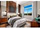 Cozy bedroom features a wood accent wall, modern decor and great natural lighting at 10848 Vista Altura Ave, Las Vegas, NV 89135