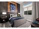 Stylish bedroom features a cool color palette, wood accent wall and patterned rug at 10848 Vista Altura Ave, Las Vegas, NV 89135