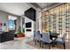 Open-concept dining room featuring a fireplace, modern lighting, and a wine display at 10848 Vista Altura Ave, Las Vegas, NV 89135
