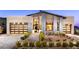Stunning modern home featuring a landscaped front yard, two car garage, and unique architectural details at 10848 Vista Altura Ave, Las Vegas, NV 89135