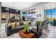 Spacious living room with high ceilings, kitchen, and seamless access to the outdoor patio at 10848 Vista Altura Ave, Las Vegas, NV 89135