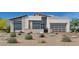 Contemporary home showcasing a modern design and desert landscaping for an appealing aesthetic at 10863 Vista Altura Ave, Las Vegas, NV 89135