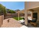 Backyard with manicured turf and landscaping, covered patio, and private, walled yard at 10952 Porto Foxi St, Las Vegas, NV 89141