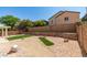 Desert landscaped backyard with gravel, rocks, and small green turf areas for low-maintenance living at 10952 Porto Foxi St, Las Vegas, NV 89141