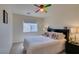 Bright bedroom showcasing a vibrant ceiling fan, window views and a comfortable queen-size bed at 10952 Porto Foxi St, Las Vegas, NV 89141