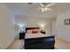 Bedroom with a ceiling fan, two nightstands and a comfortable bed with decorative pillows at 10952 Porto Foxi St, Las Vegas, NV 89141