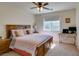 Cozy bedroom features a ceiling fan, a window with natural light and a comfortable bed at 10952 Porto Foxi St, Las Vegas, NV 89141