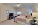 Relaxing bedroom featuring a ceiling fan, a television and a comfortable bed at 10952 Porto Foxi St, Las Vegas, NV 89141