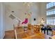 Bright dining and living room with wood floors and staircase to the second story at 10952 Porto Foxi St, Las Vegas, NV 89141