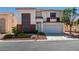 Two-story home featuring a red tiled roof, brick accents, and a two-car garage at 10952 Porto Foxi St, Las Vegas, NV 89141