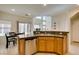 Well-designed kitchen features stainless steel dishwasher and bar seating at 10952 Porto Foxi St, Las Vegas, NV 89141