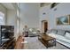 Bright living room features high ceilings, large windows, and comfortable seating arrangement at 10952 Porto Foxi St, Las Vegas, NV 89141