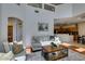 Bright living room features high ceilings, large windows, and comfortable seating arrangement at 10952 Porto Foxi St, Las Vegas, NV 89141