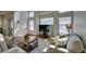 Bright living room features high ceilings, large windows, and comfortable seating arrangement at 10952 Porto Foxi St, Las Vegas, NV 89141