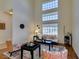 Living area featuring tall windows, modern decor, and hardwood floors at 10952 Porto Foxi St, Las Vegas, NV 89141