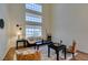 Living area featuring tall windows, modern decor, and hardwood floors at 10952 Porto Foxi St, Las Vegas, NV 89141