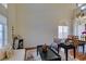 Open-concept living and dining area with high ceilings and large windows at 10952 Porto Foxi St, Las Vegas, NV 89141