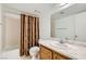 Bathroom with a marble sink, a toilet, and a bathtub with a shower and neutral-toned shower curtain at 1104 Pinto Rock Ln # 101, Las Vegas, NV 89128