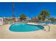 Community pool featuring lounge chairs, and surrounding buildings at 1104 Pinto Rock Ln # 101, Las Vegas, NV 89128