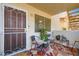Inviting front porch with seating, bright rug, and charming decor at 1104 Pinto Rock Ln # 101, Las Vegas, NV 89128