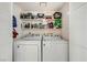 Convenient laundry area with side by side washer and dryer and shelving for storage at 1104 Pinto Rock Ln # 101, Las Vegas, NV 89128